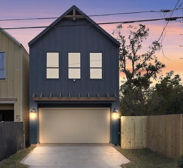 5306 San Juan St, Houston, TX 77020 - view of front of property featuring board and batten siding, concrete driveway, and a garage