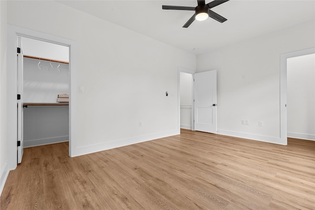 5306 San Juan St, Houston, TX 77020 - unfurnished bedroom featuring a walk in closet, light wood-style floors, baseboards, and a closet