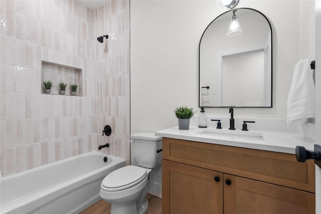 5306 San Juan St, Houston, TX 77020 - bathroom featuring vanity, toilet, washtub / shower combination, and wood finished floors