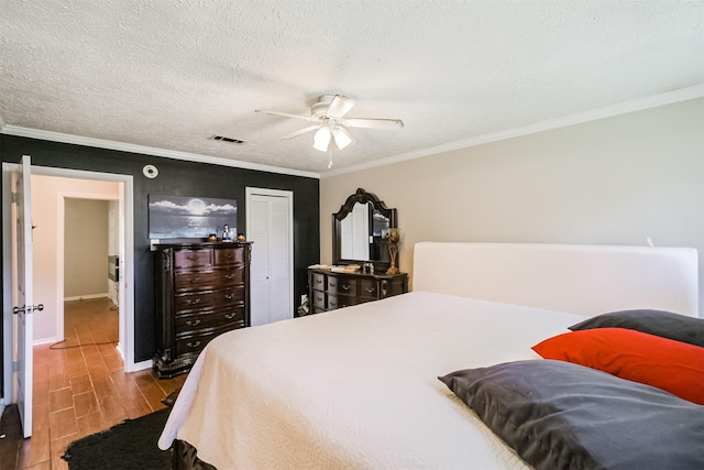 1510 Elmscott Dr, Sugar Land, TX 77498 - bedroom with wood finished floors, ornamental molding, a closet, baseboards, and a textured ceiling