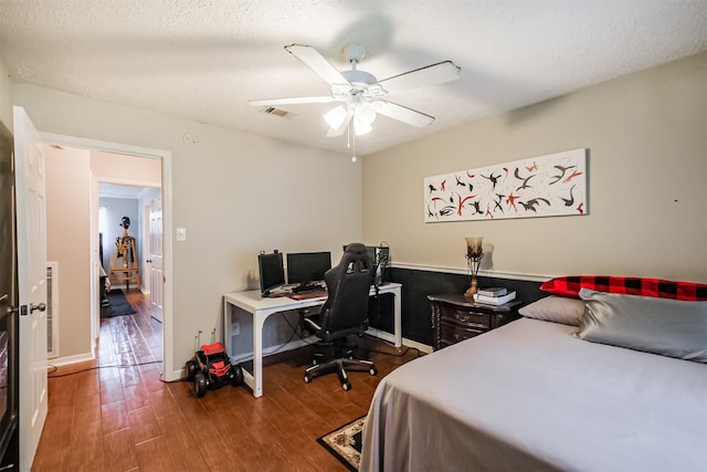 1510 Elmscott Dr, Sugar Land, TX 77498 - bedroom featuring wood finished floors, an office area, a ceiling fan, and baseboards