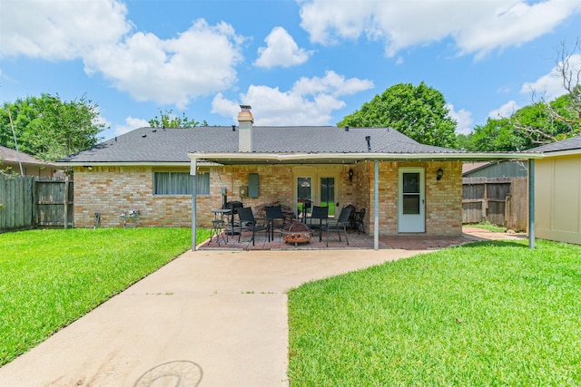 1510 Elmscott Dr, Sugar Land, TX 77498 - back of property with brick siding, a chimney, and a patio