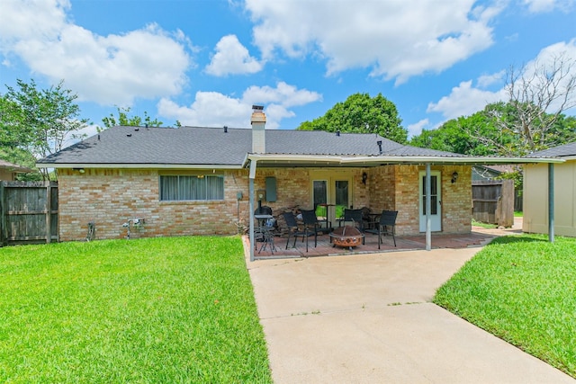 1510 Elmscott Dr, Sugar Land, TX 77498 - rear view of house featuring brick siding, a patio area, a fire pit, and a chimney