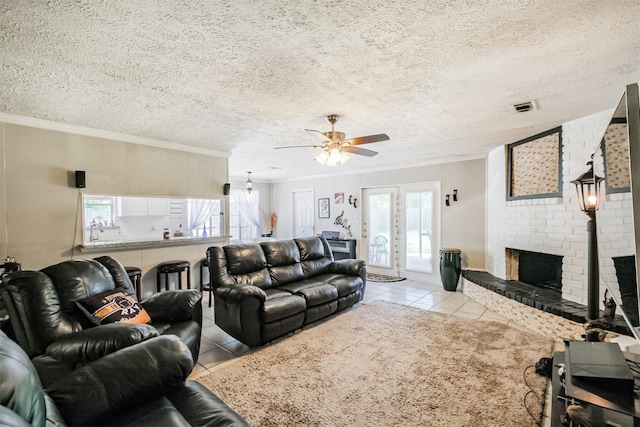 1510 Elmscott Dr, Sugar Land, TX 77498 - living room featuring ornamental molding, ceiling fan, tile patterned floors, a fireplace, and a textured ceiling
