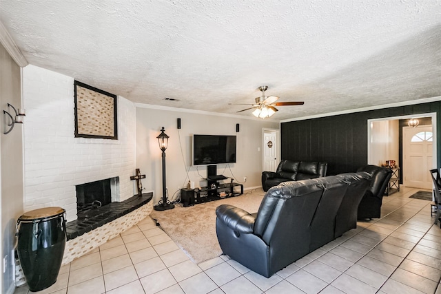 1510 Elmscott Dr, Sugar Land, TX 77498 - living room featuring a brick fireplace, light tile patterned flooring, a ceiling fan, ornamental molding, and a textured ceiling