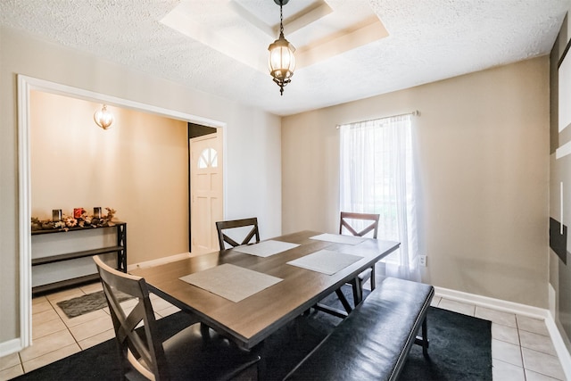 1510 Elmscott Dr, Sugar Land, TX 77498 - dining room with light tile patterned floors, a textured ceiling, and baseboards