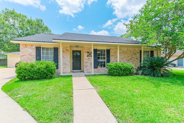 1510 Elmscott Dr, Sugar Land, TX 77498 - ranch-style home with a front lawn, a garage, covered porch, brick siding, and roof with shingles
