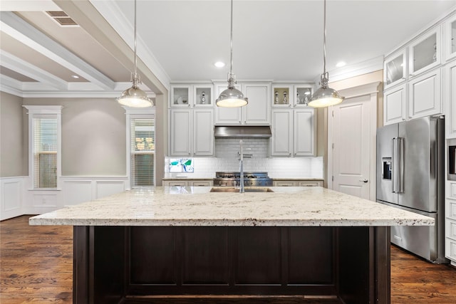 428 W 26th St, Houston, TX 77008 - kitchen with high end fridge, ornamental molding, plenty of natural light, an island with sink, and under cabinet range hood
