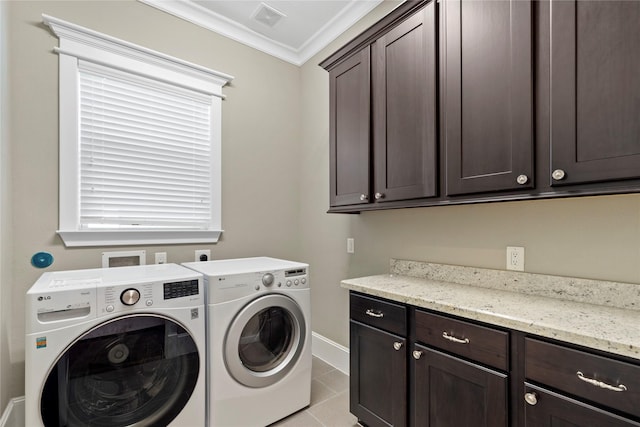 428 W 26th St, Houston, TX 77008 - laundry area featuring washing machine and clothes dryer, cabinet space, ornamental molding, baseboards, and light tile patterned flooring