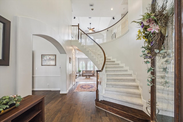13627 Ashley Run, Houston, TX 77077 - foyer entrance featuring stairway, a ceiling fan, wood-type flooring, arched walkways, and baseboards