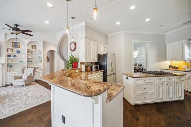 13627 Ashley Run, Houston, TX 77077 - kitchen featuring appliances with stainless steel finishes, ornamental molding, light stone counters, dark wood-type flooring, and recessed lighting