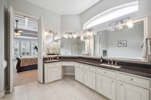 13627 Ashley Run, Houston, TX 77077 - full bathroom with connected bathroom, plenty of natural light, double vanity, and ceiling fan