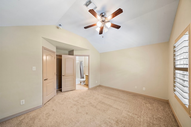 6823 Rosemont Park Ln, Katy, TX 77494 - unfurnished bedroom with light colored carpet, vaulted ceiling, baseboards, and ensuite bath