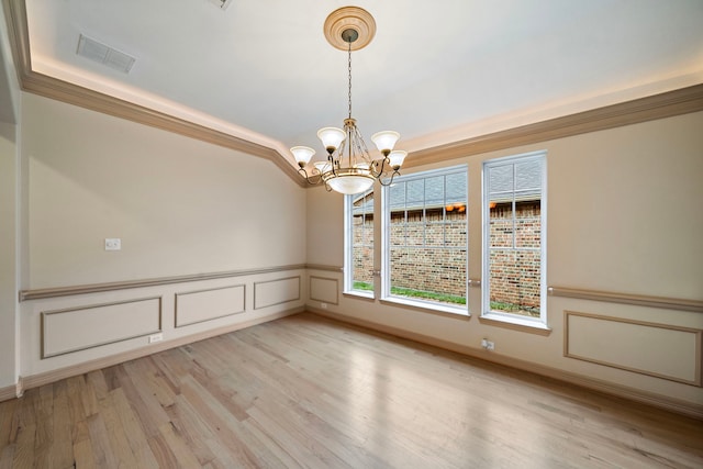 6823 Rosemont Park Ln, Katy, TX 77494 - spare room with a chandelier, light wood-type flooring, and a wainscoted wall