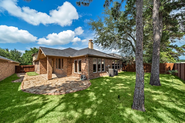 6823 Rosemont Park Ln, Katy, TX 77494 - rear view of house featuring brick siding, a chimney, and a patio area