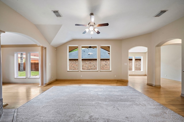 6823 Rosemont Park Ln, Katy, TX 77494 - unfurnished living room with arched walkways, ornate columns, ceiling fan, light wood finished floors, and lofted ceiling