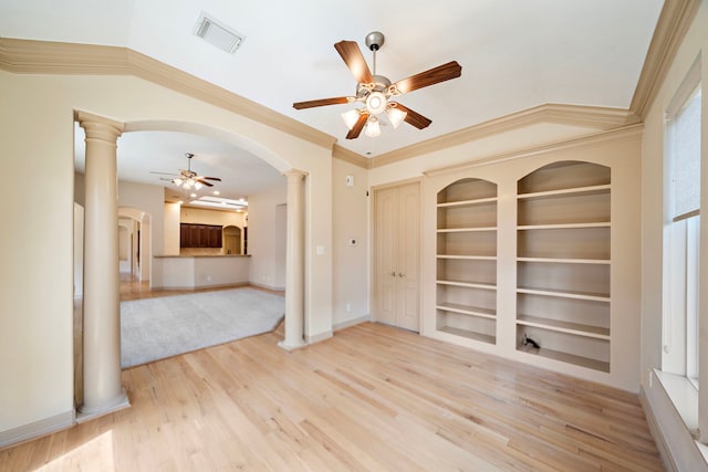6823 Rosemont Park Ln, Katy, TX 77494 - unfurnished room with a ceiling fan, arched walkways, built in features, wood finished floors, and crown molding