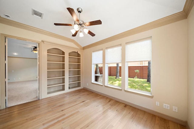 6823 Rosemont Park Ln, Katy, TX 77494 - empty room with ceiling fan, ornamental molding, baseboards, wood finished floors, and built in features