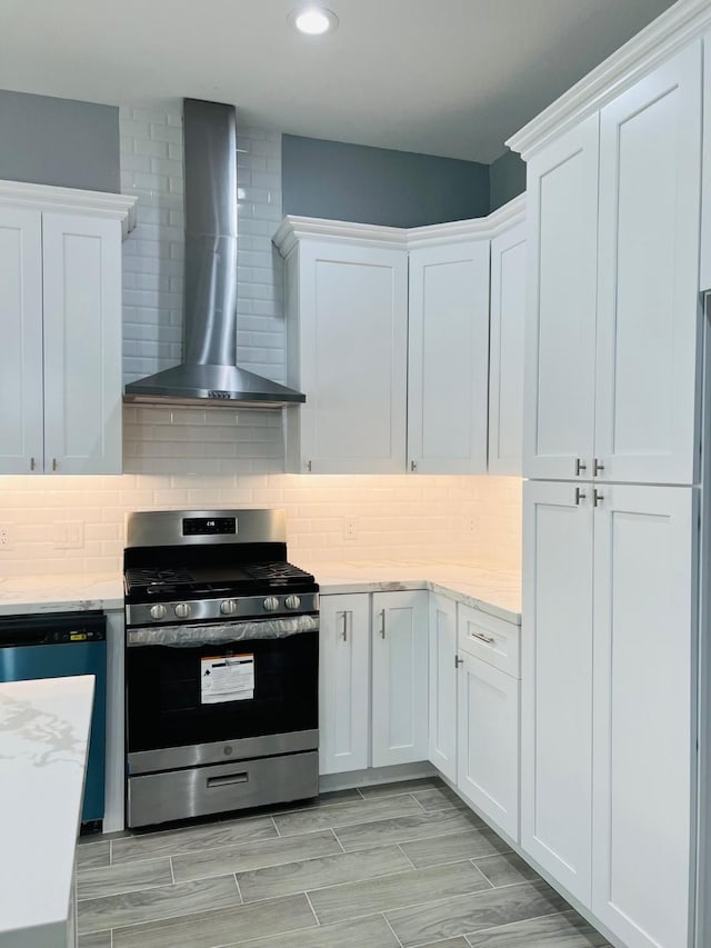 6804 Foster St, Houston, TX 77021 - kitchen with gas stove, wall chimney range hood, recessed lighting, white cabinetry, and dishwashing machine