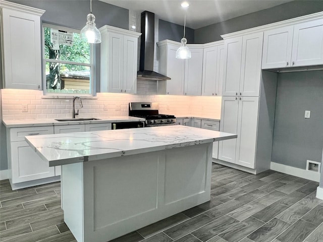 6804 Foster St, Houston, TX 77021 - kitchen featuring a sink, wall chimney range hood, stainless steel range with gas cooktop, tasteful backsplash, and recessed lighting