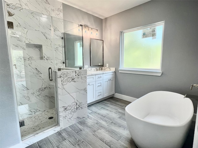 6804 Foster St, Houston, TX 77021 - full bath featuring vanity, a marble finish shower, a freestanding bath, and baseboards