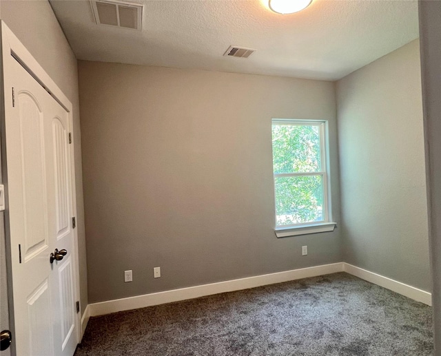 6804 Foster St, Houston, TX 77021 - spare room with carpet floors, baseboards, and a textured ceiling