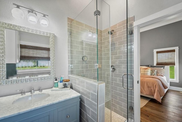 539 Elm St, New Ulm, TX 78950 - ensuite bathroom featuring wood finished floors, a shower stall, and vanity