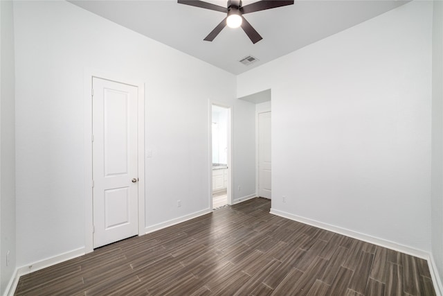 7822 Taronga Ln, Richmond, TX 77407 - unfurnished bedroom with dark wood finished floors, baseboards, ensuite bath, and ceiling fan