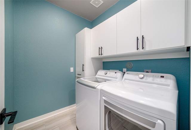 7822 Taronga Ln, Richmond, TX 77407 - washroom with washer and clothes dryer, cabinet space, and baseboards