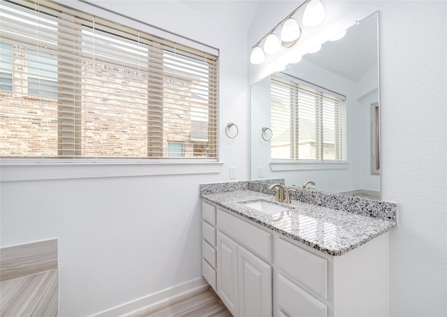 7822 Taronga Ln, Richmond, TX 77407 - bathroom featuring vanity, baseboards, and wood finished floors