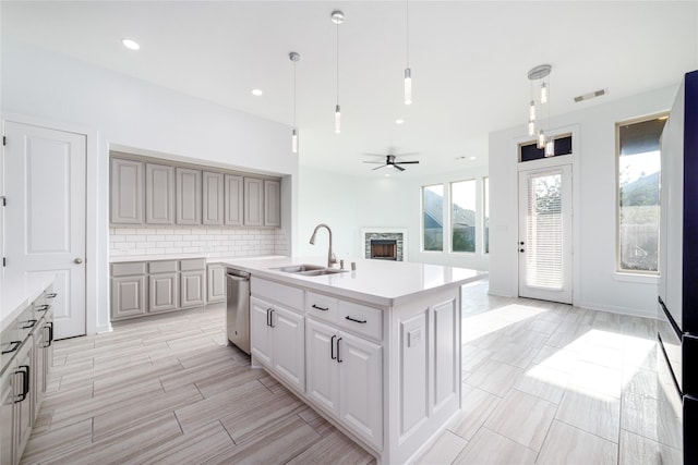 7822 Taronga Ln, Richmond, TX 77407 - kitchen featuring a sink, stainless steel dishwasher, healthy amount of natural light, backsplash, and recessed lighting