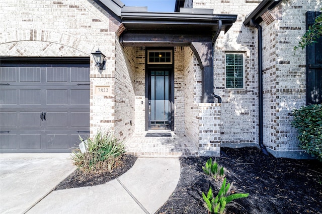 7822 Taronga Ln, Richmond, TX 77407 - doorway to property featuring a garage, brick siding, and concrete driveway