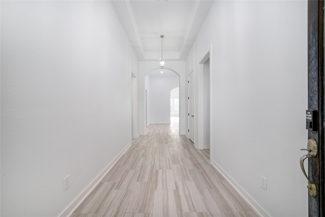 7822 Taronga Ln, Richmond, TX 77407 - hallway featuring arched walkways, baseboards, and light wood-style floors
