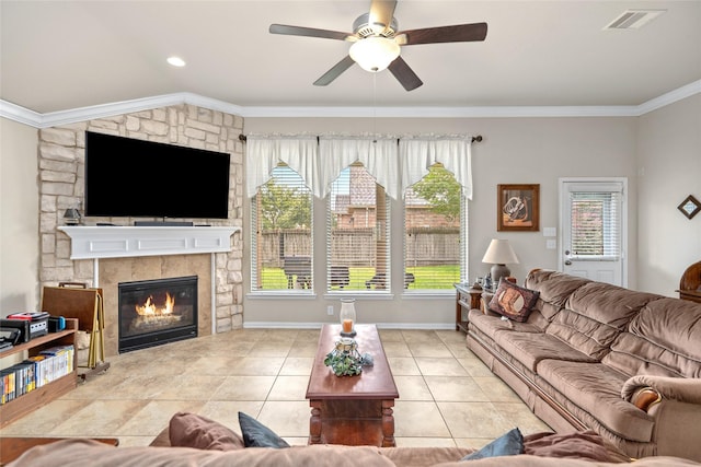 207 Lockridge Hill Ln, Richmond, TX 77469 - tiled living area with ceiling fan, ornamental molding, a fireplace, and baseboards