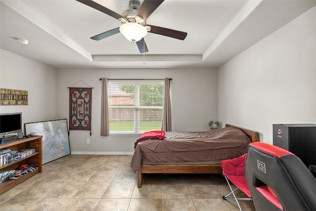 207 Lockridge Hill Ln, Richmond, TX 77469 - bedroom with a tray ceiling, baseboards, and a ceiling fan