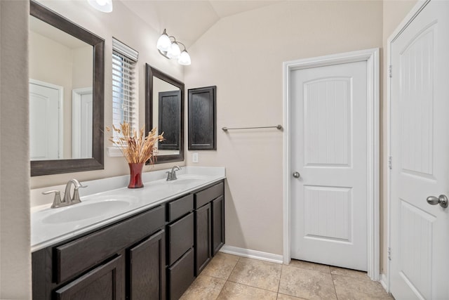 207 Lockridge Hill Ln, Richmond, TX 77469 - full bath featuring double vanity, vaulted ceiling, tile patterned floors, and baseboards