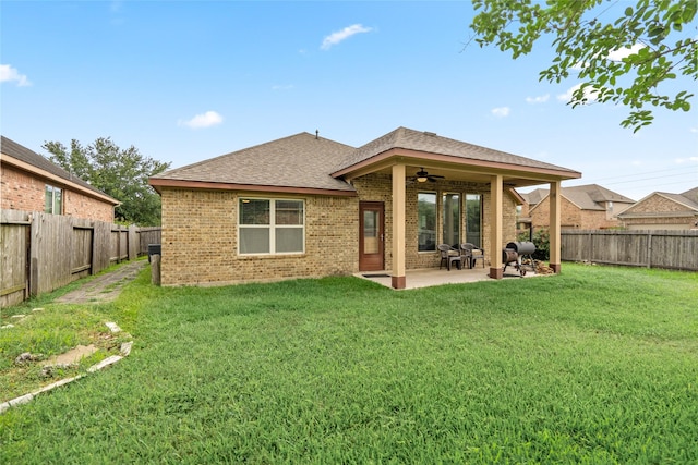207 Lockridge Hill Ln, Richmond, TX 77469 - back of house with a ceiling fan, brick siding, a shingled roof, and a patio
