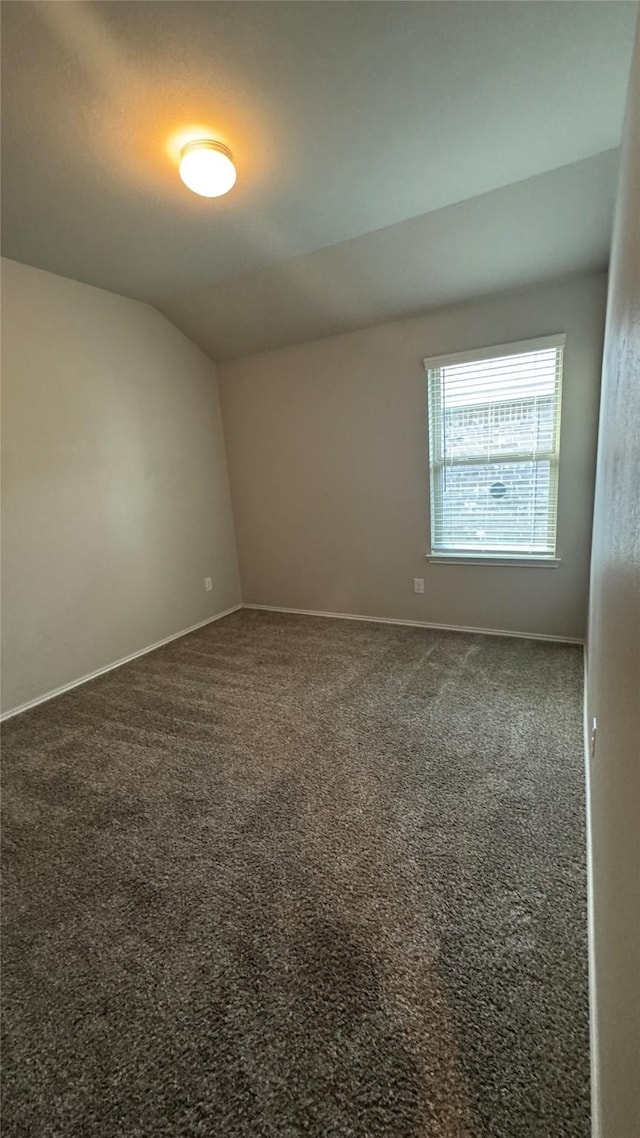 13909 Payette Arbor Ct, Conroe, TX 77384 - empty room featuring carpet floors, lofted ceiling, and baseboards