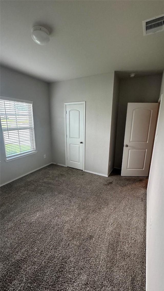 13909 Payette Arbor Ct, Conroe, TX 77384 - unfurnished bedroom featuring carpet flooring and baseboards