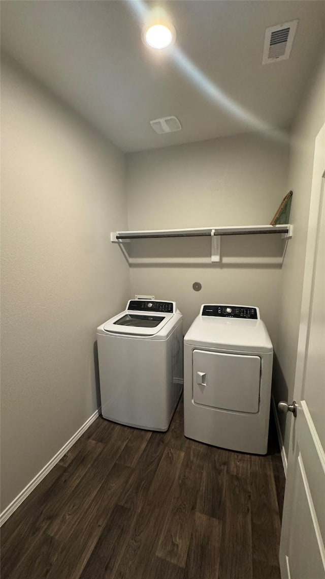 13909 Payette Arbor Ct, Conroe, TX 77384 - laundry room featuring washer and clothes dryer, dark wood-style flooring, and baseboards