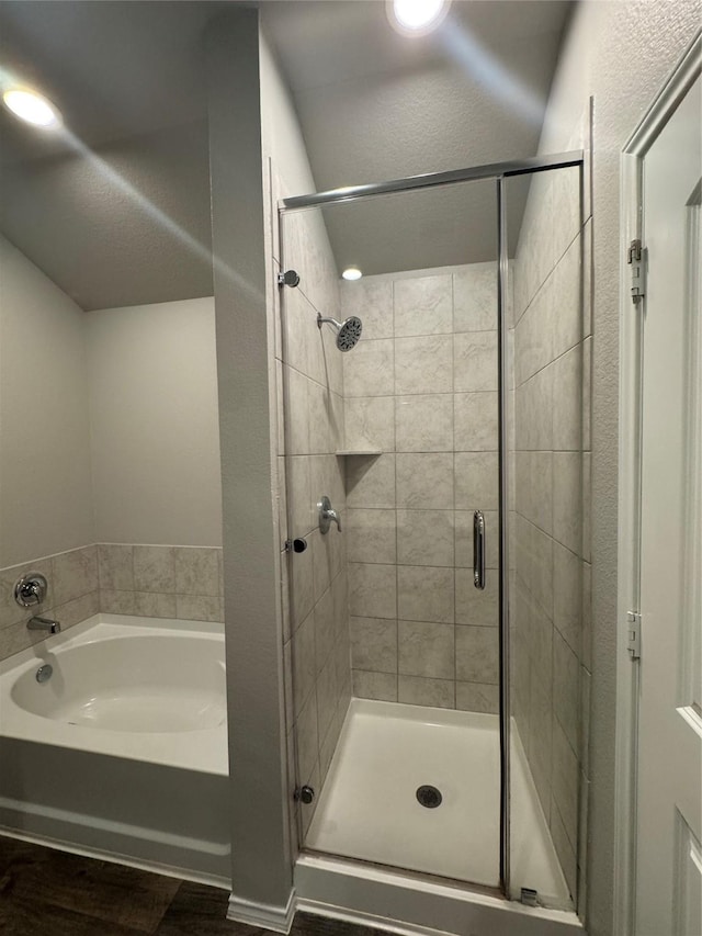 13909 Payette Arbor Ct, Conroe, TX 77384 - bathroom with a bath, a stall shower, and wood finished floors