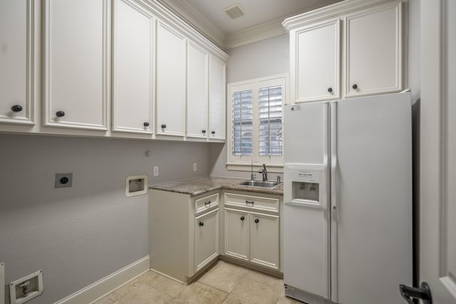 14214 Heidi Oaks Ln, Humble, TX 77396 - laundry area featuring cabinet space, washer hookup, hookup for an electric dryer, crown molding, and baseboards