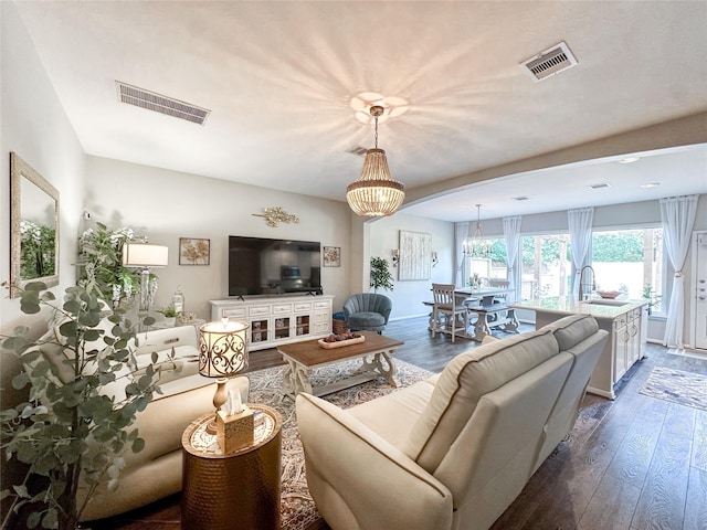 10521 Day Trail Ln, Spring, TX 77379 - living room with a chandelier, dark wood finished floors, and baseboards