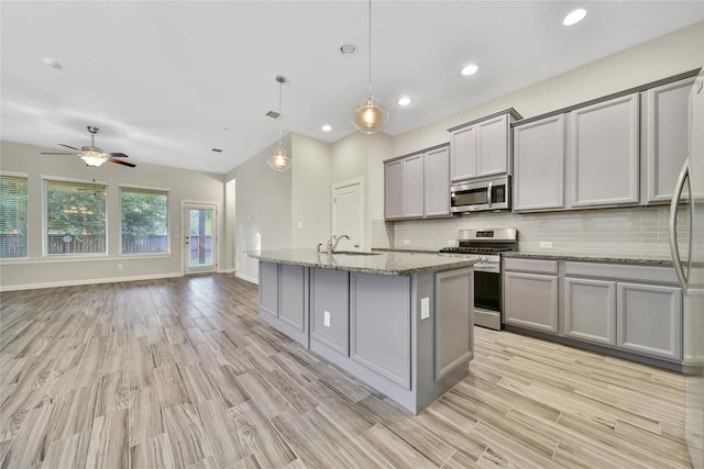 117 Saddle Dr, Houston, TX 77065 - kitchen with appliances with stainless steel finishes, gray cabinets, a sink, decorative backsplash, and recessed lighting