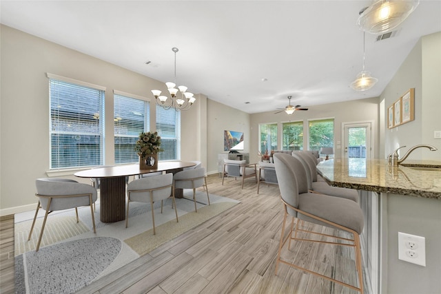 117 Saddle Dr, Houston, TX 77065 - dining area with light wood-style flooring, baseboards, a chandelier, and ceiling fan