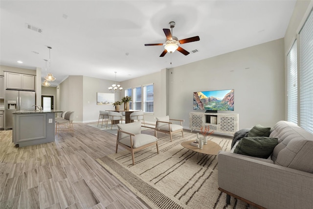117 Saddle Dr, Houston, TX 77065 - living area featuring ceiling fan, baseboards, a chandelier, light wood-style flooring, and recessed lighting