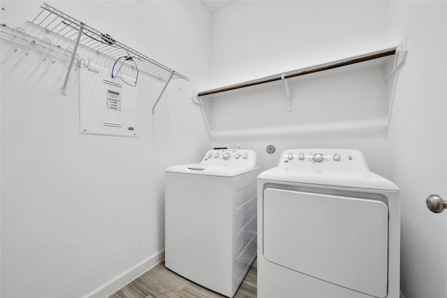 117 Saddle Dr, Houston, TX 77065 - washroom with washer and dryer, light wood-style floors, and baseboards