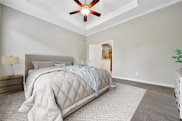 117 Saddle Dr, Houston, TX 77065 - carpeted bedroom with a tray ceiling, ornamental molding, baseboards, ceiling fan, and ensuite bathroom