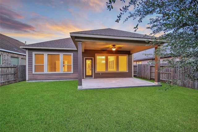 117 Saddle Dr, Houston, TX 77065 - back of house at dusk featuring a patio and roof with shingles