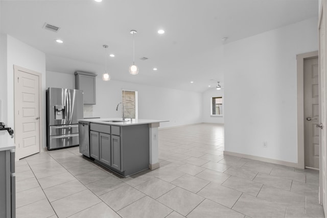 7414 Keystone Blossom Trl, Richmond, TX 77407 - kitchen with stainless steel appliances, gray cabinets, a sink, light countertops, and light tile patterned flooring